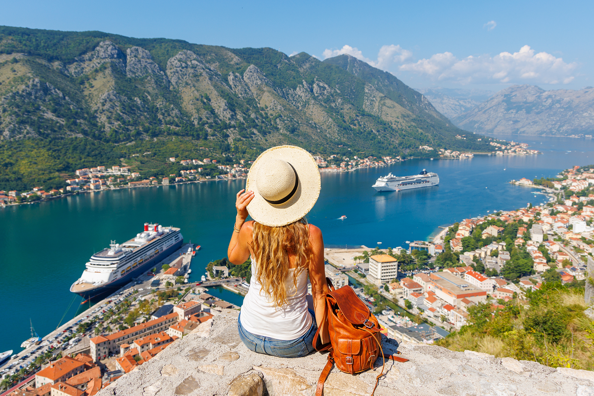 Woman tourist enjoying panoramic view of Kotor Bay- travel, tour tourism, vacation in Montenegro, Europe